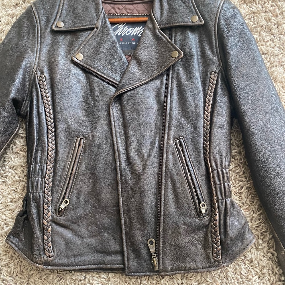 Genuine dark brown leather jacket with braided detailing.